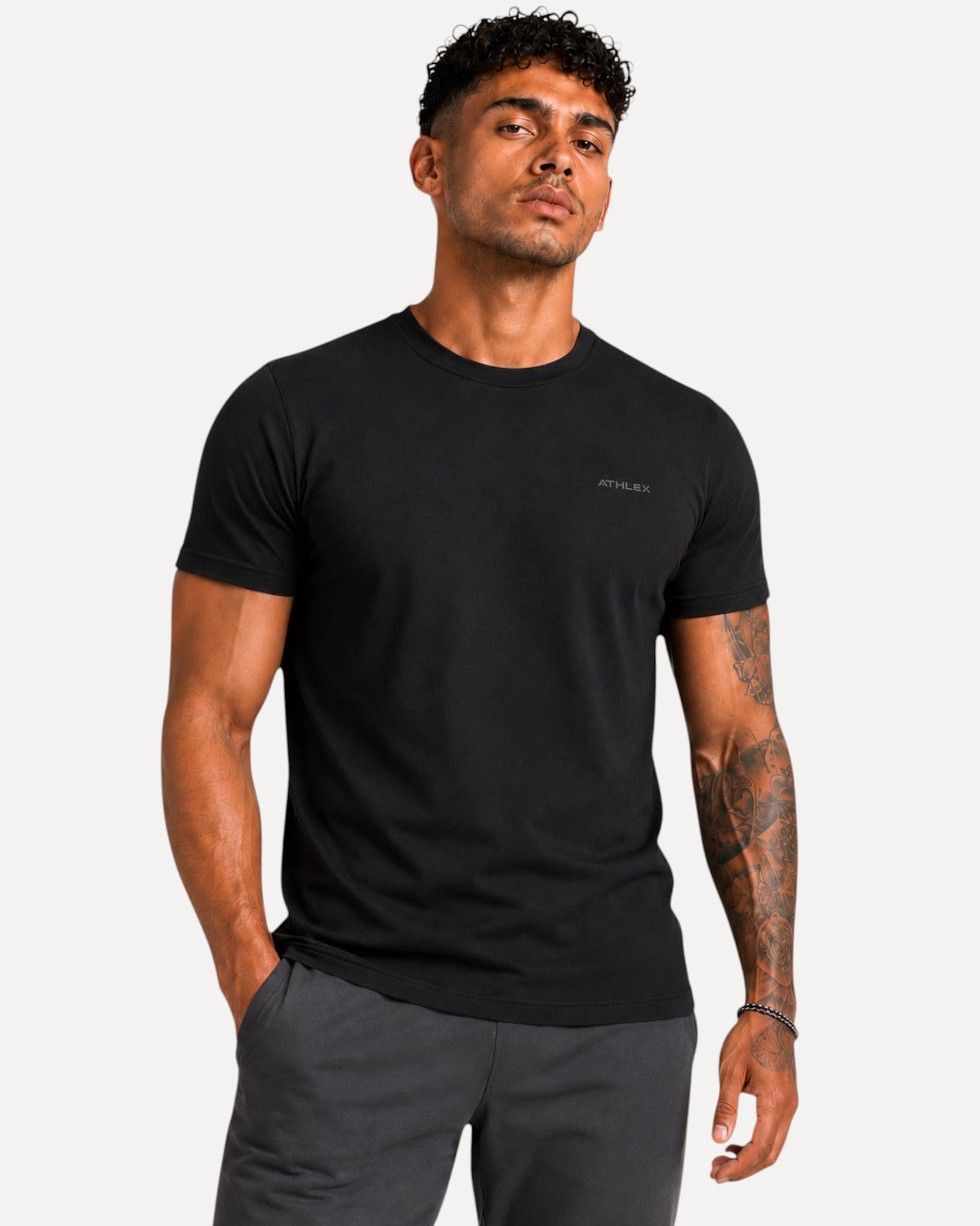 My Store ATHLEX men's black cotton jersey t-shirt with a minimal chest logo worn by a model with an athletic fit.