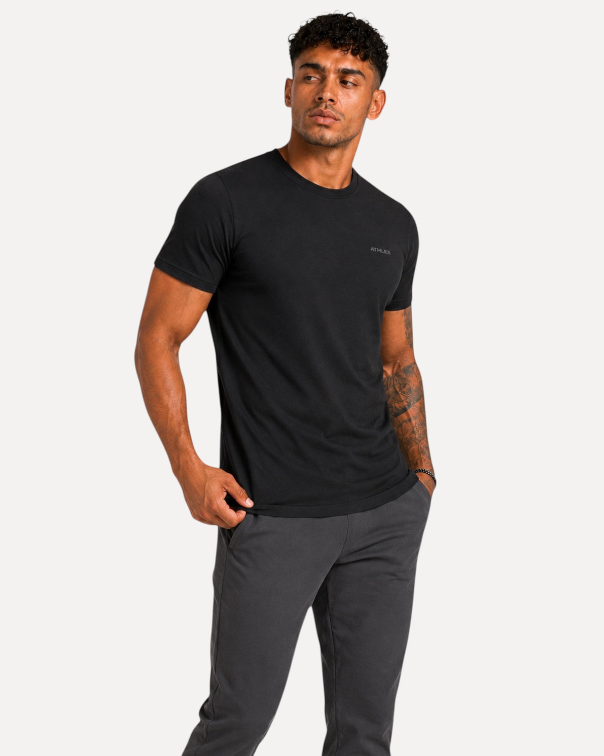 My Store ATHLEX men's minimal black cotton t-shirt with a small chest logo worn by a model in an athletic fit