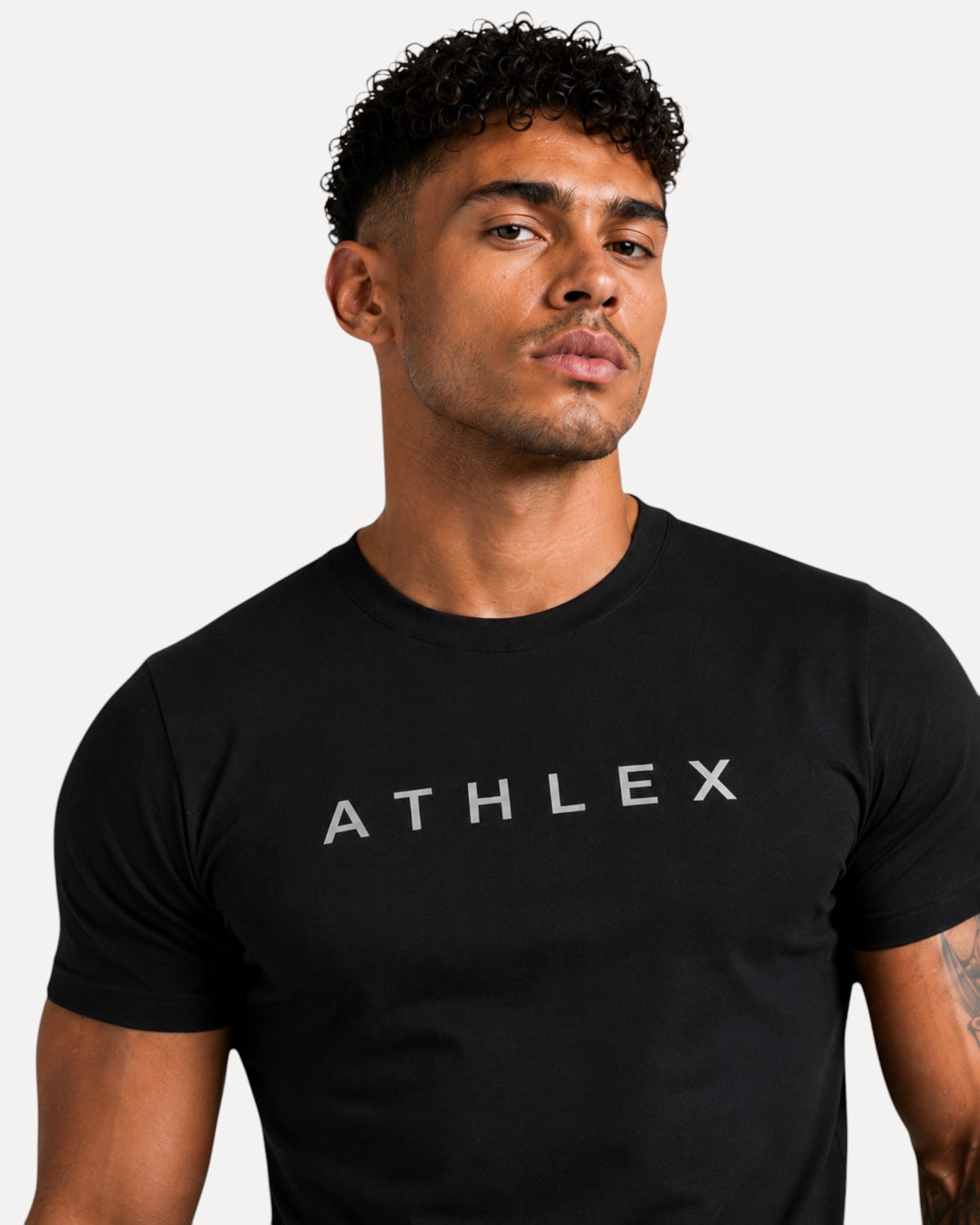 My Store ATHLEX ShadowFlex black cotton tee worn by a man with a modern athletic fit and grey logo branding