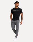 My Store ATHLEX ShadowFlex black cotton tee worn by a fit model with grey joggers and white sneakers.