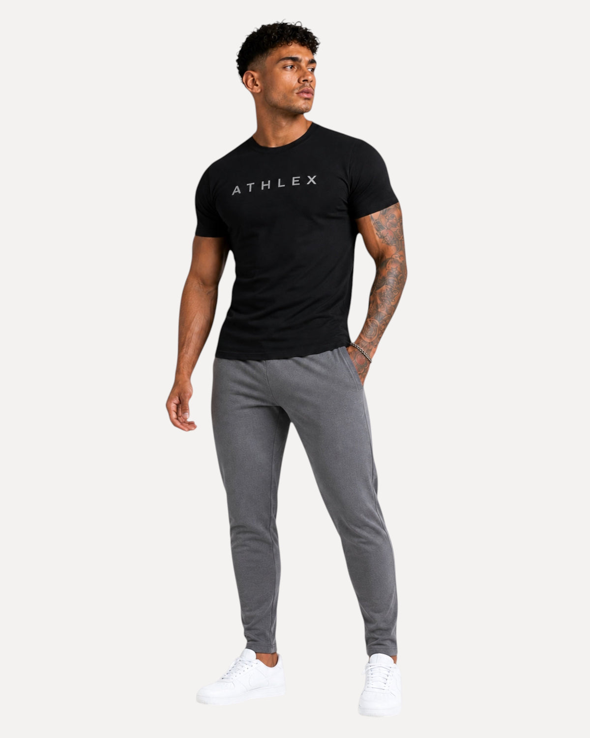 My Store ATHLEX ShadowFlex black cotton tee worn by a fit man with grey joggers and white sneakers