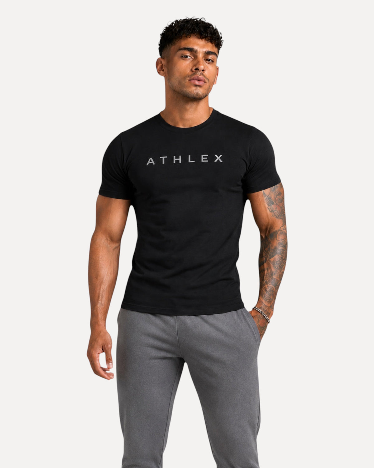My Store ATHLEX ShadowFlex black cotton tee with grey logo worn by a fit model with tattoos