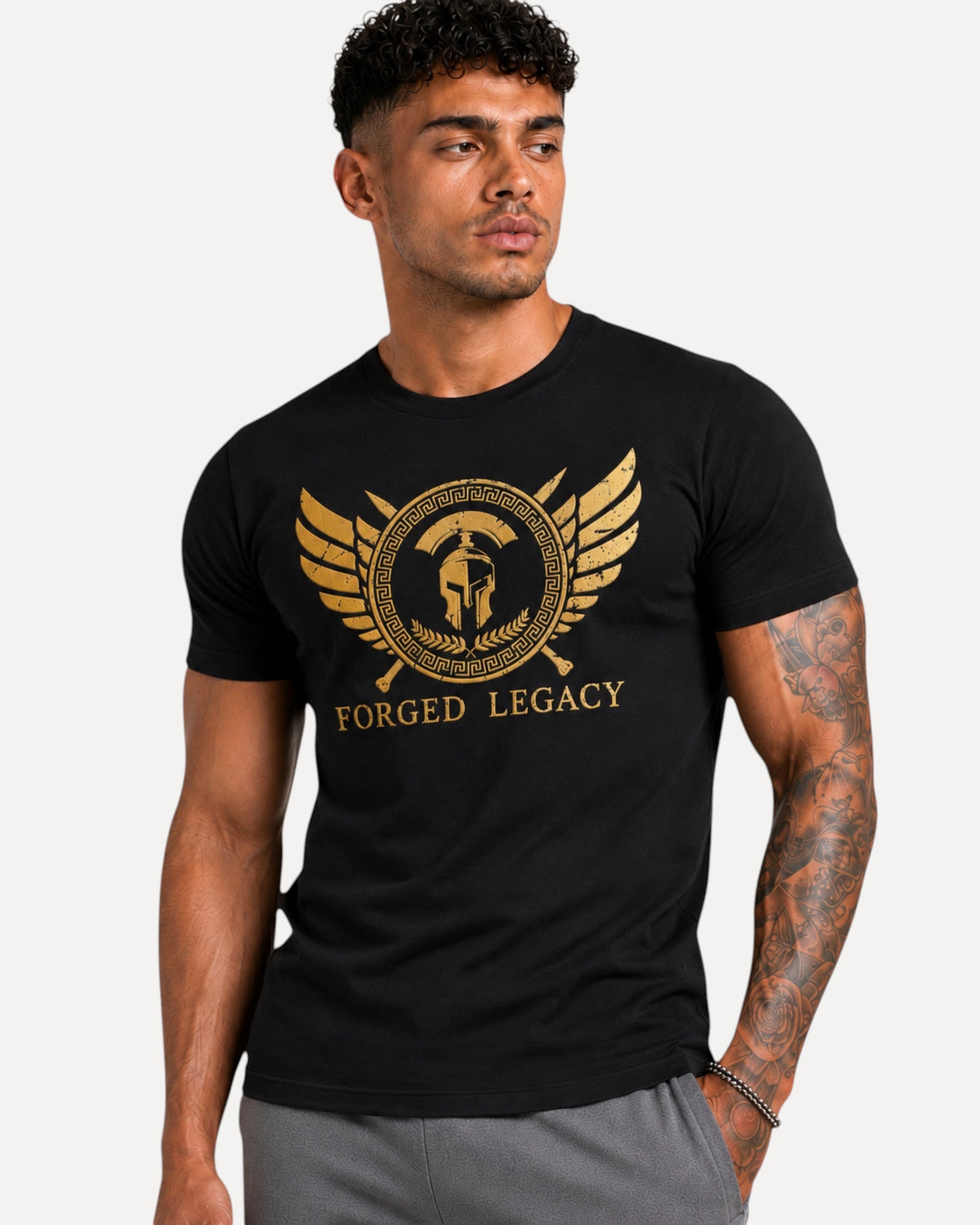 My Store ATHLEX black cotton t-shirt with gold warrior helmet and wing graphic on a muscular man