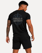 My Store Athlex black athletic t-shirt featuring a Forged in Adversity compass graphic on the back worn by a man