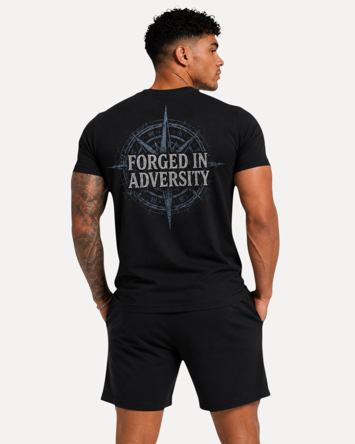My Store Athlex black athletic t-shirt with Forged in Adversity compass back graphic worn by a muscular man