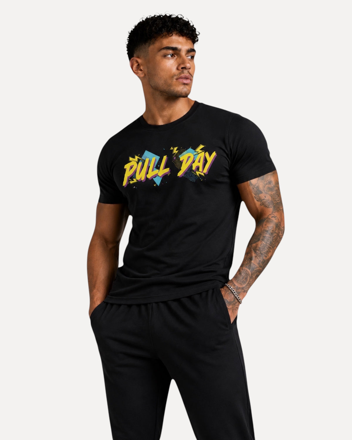 My Store ATHLEX black cotton graphic t-shirt with colorful Pull Day print worn by a fit man in an athletic studio