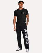 My Store Athlex AX black cotton t-shirt with white logo worn by a model with joggers and sneakers