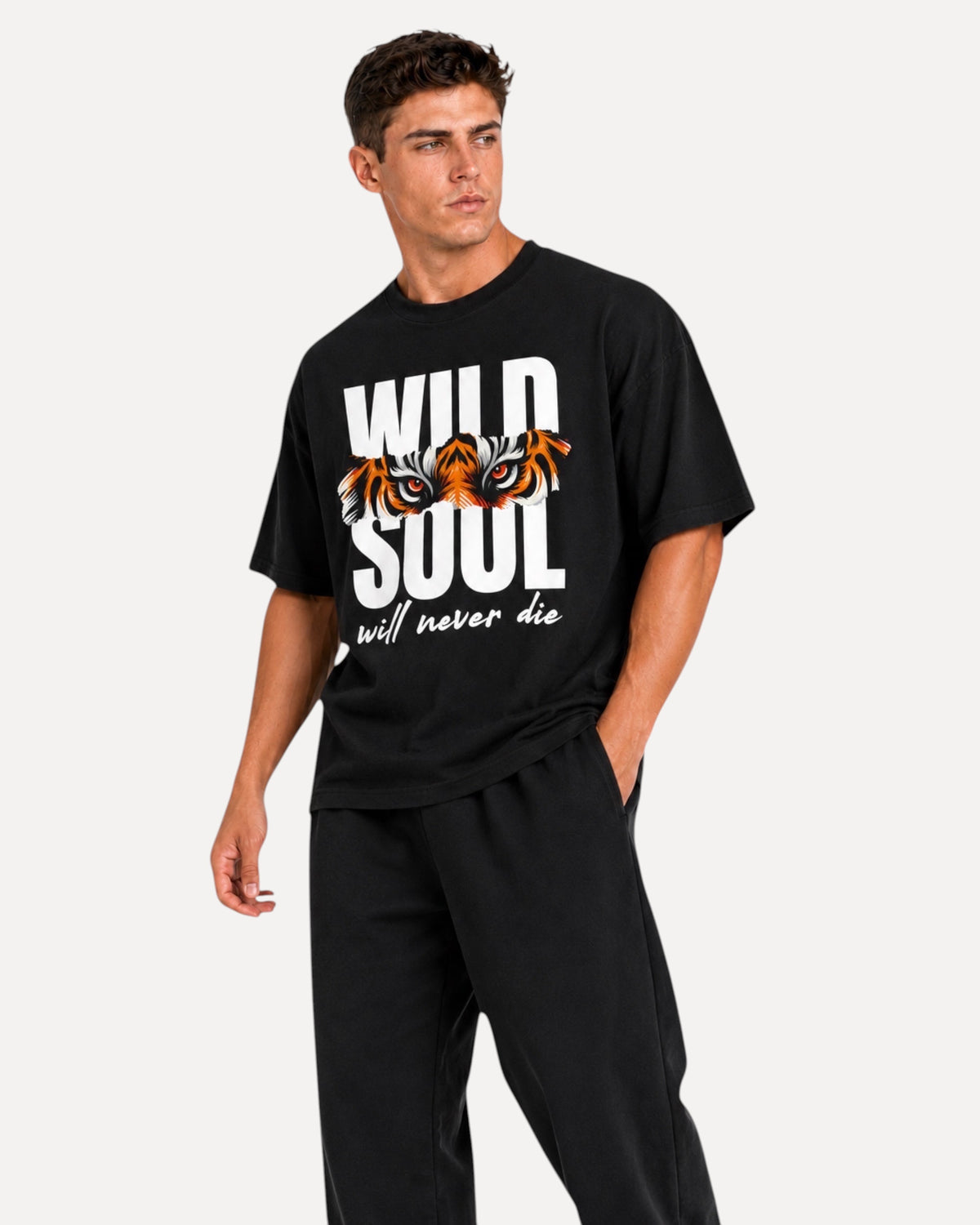 My Store ATHLEX black oversized graphic tee featuring a tiger eye print and Wild Soul text worn by a male model