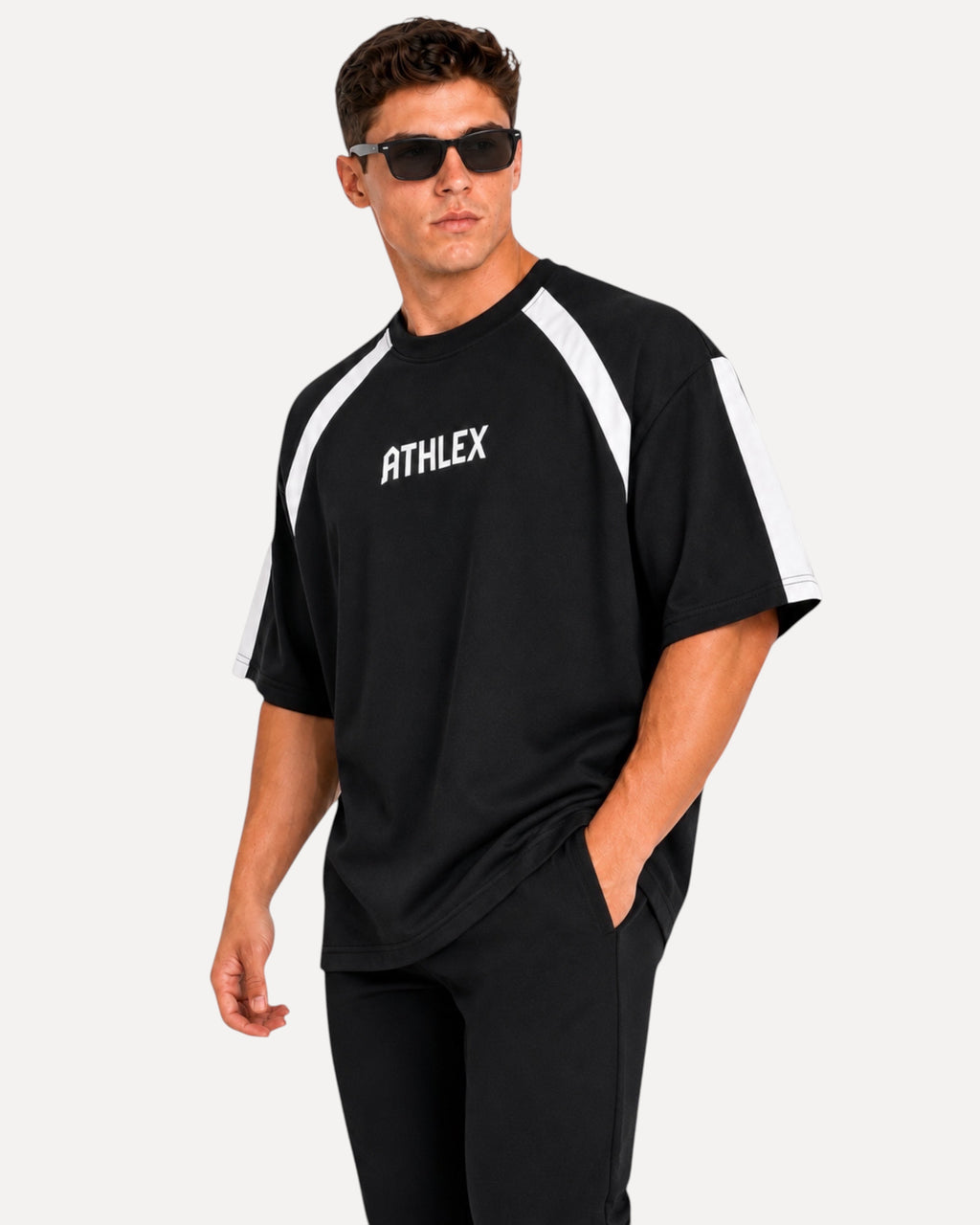 My Store ATHLEX men's black oversized performance t-shirt with white shoulder panels and logo, worn by a male model.