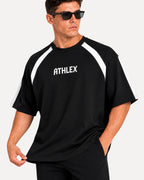 My Store ATHLEX black oversized performance t-shirt with white shoulder panels and logo on a male model wearing shades