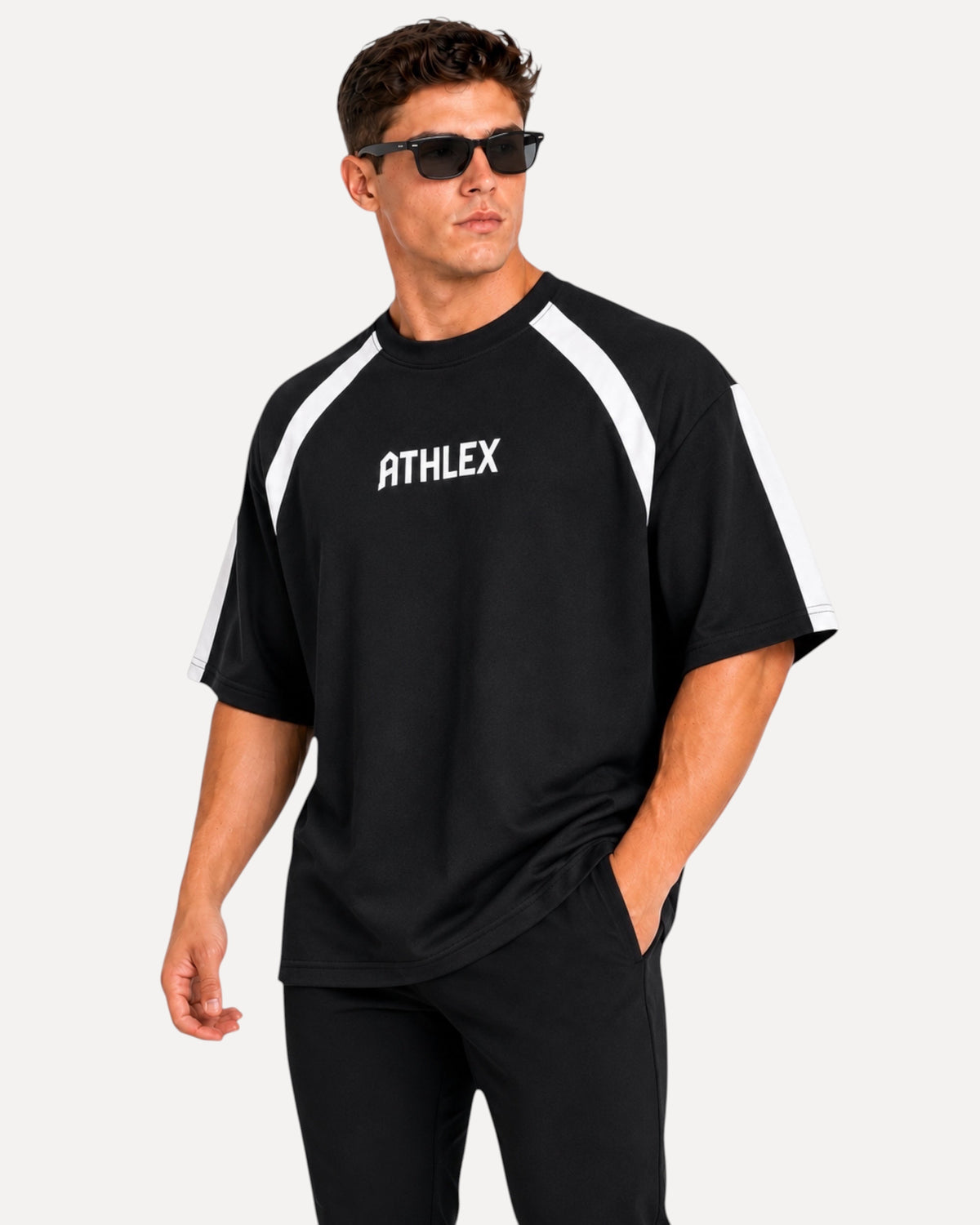 My Store ATHLEX men's black oversized performance t-shirt with white shoulder panels and logo, worn by a male model.