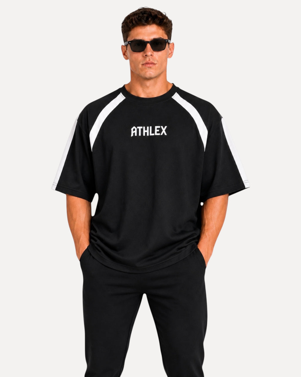 My Store ATHLEX men's black oversized performance t-shirt with white shoulder panels and crew neck, worn by a model.