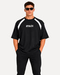 My Store ATHLEX men's black oversized performance t-shirt with white shoulder panels and crew neck, worn by a model.