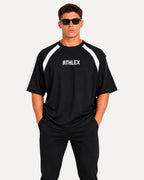 My Store ATHLEX men's black oversized performance t-shirt with white shoulder panels and crew neck, worn by a model.