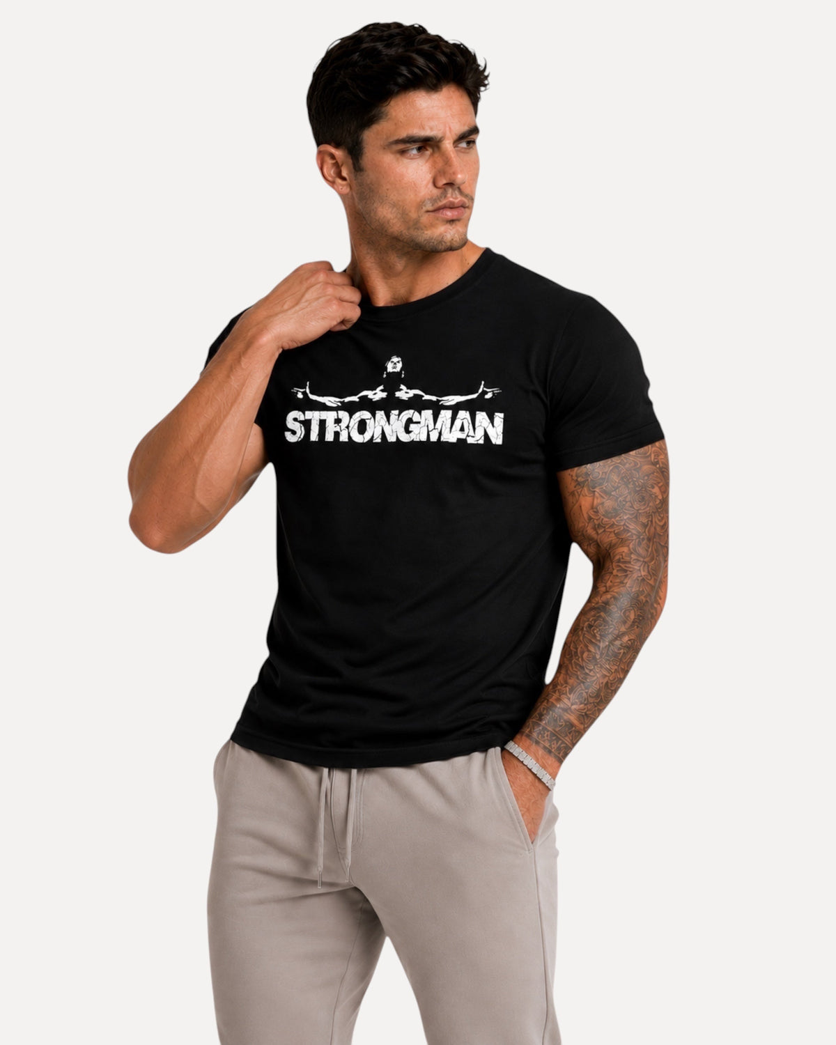 My Store ATHLEX black cotton graphic tee with Strongman print worn by a muscular man in grey joggers