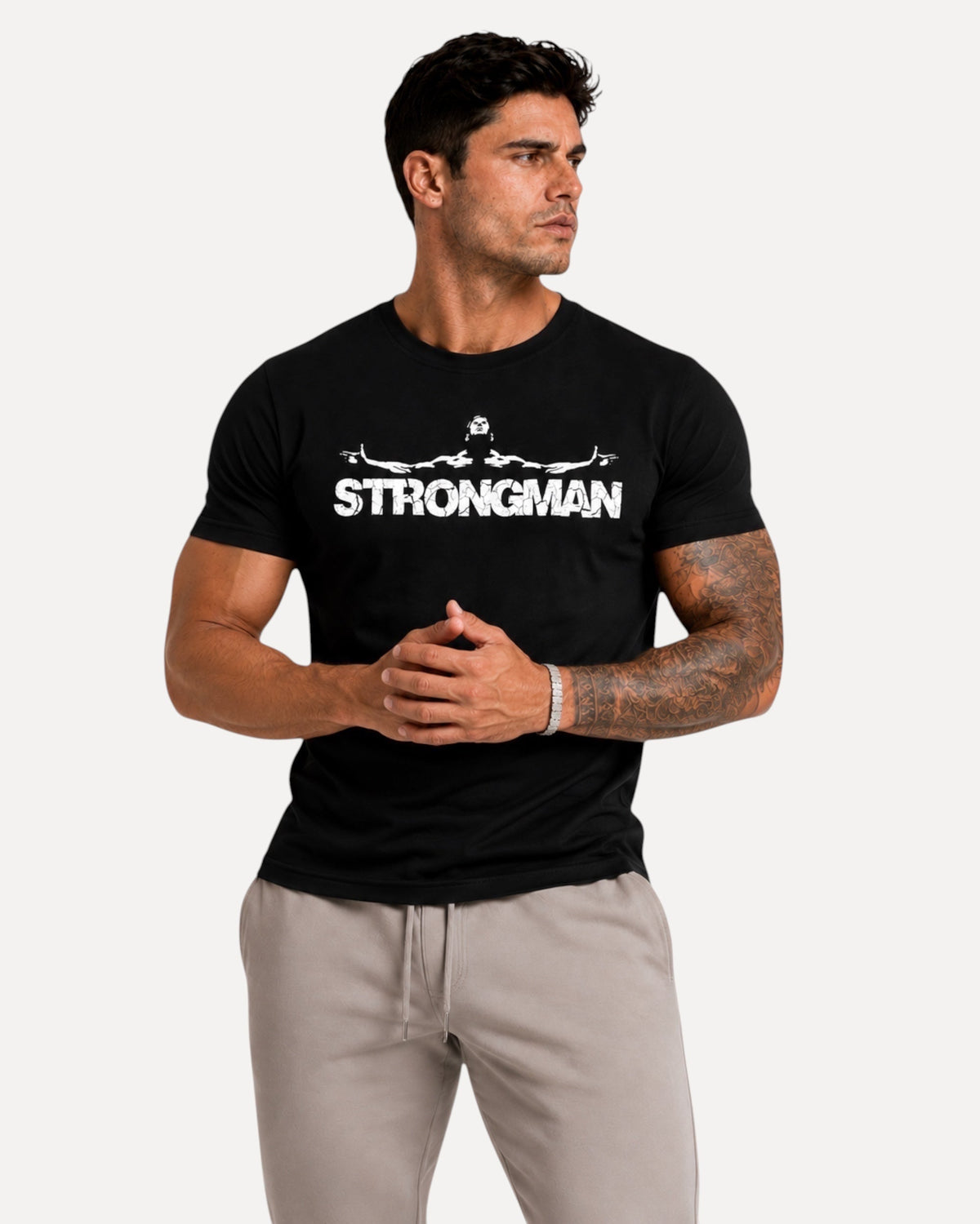 My Store ATHLEX black cotton graphic tee with Strongman print worn by a muscular man in grey joggers
