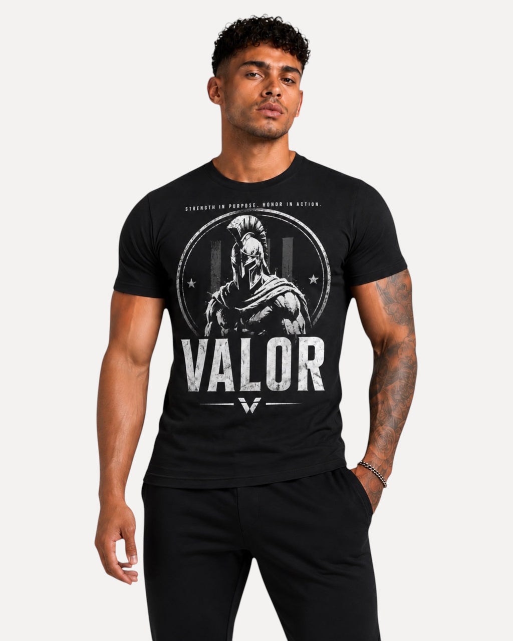 My Store ATHLEX black cotton graphic tee featuring a white warrior helmet print and VALOR text on a fit male model.