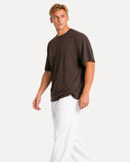 My Store Athlex oversized chocolate brown t-shirt worn by a man with white joggers for a relaxed streetwear look