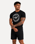 My Store ATHLEX Conquer black graphic t-shirt with white circular chest print worn by a muscular man