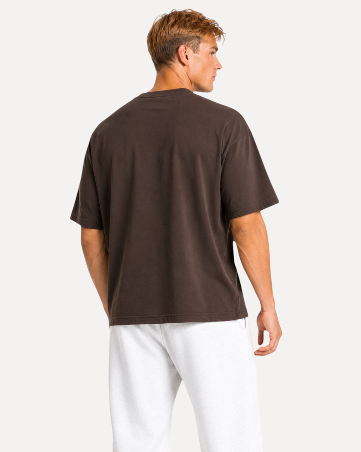 Back view of a man wearing a My Store Athlex oversized chocolate brown t-shirt with a relaxed fit and soft drape.